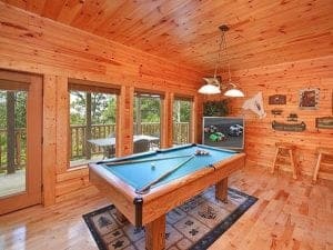 A pool table and a TV at a cabin in Gatlinburg.