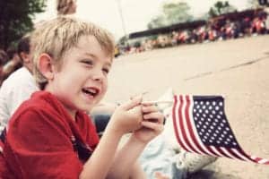 kid waving american flag